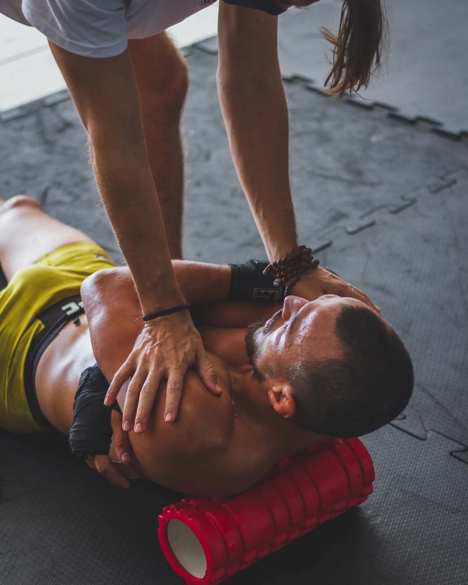 Athlete completing sports recovery work with trainer guidance