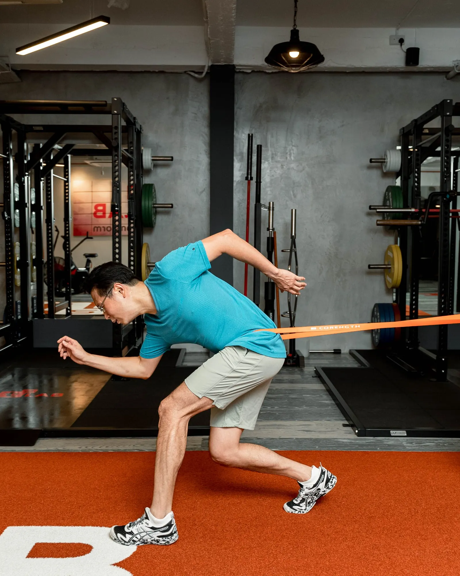 Coach supervising athlete during strength and conditioning training